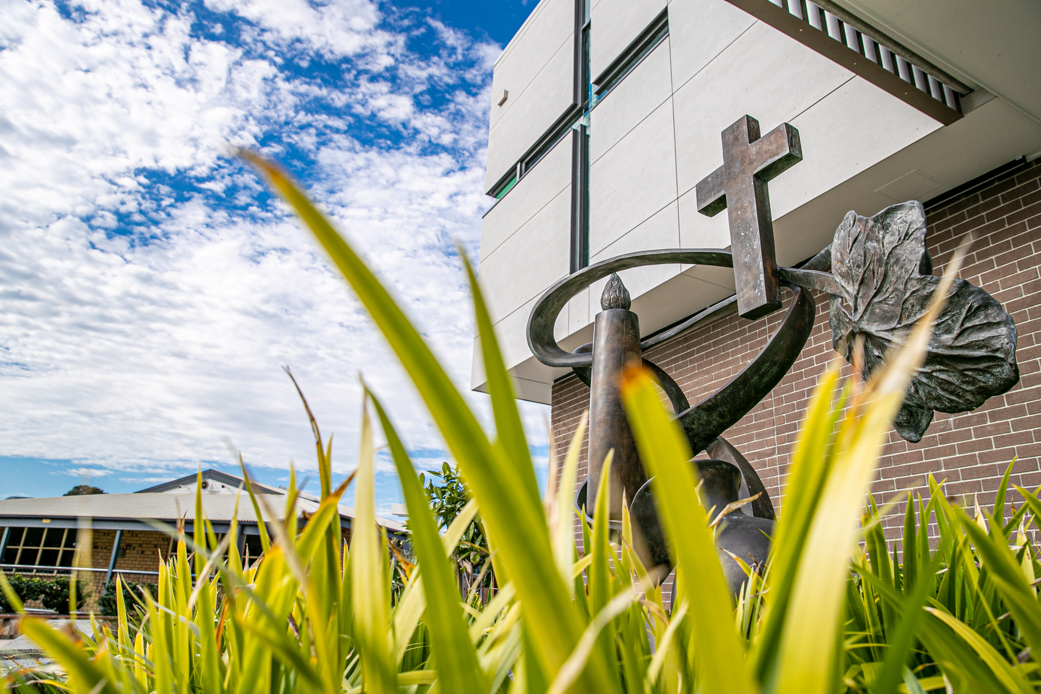 Catholic faith symbol with cross and sculptural form at Carmel College reflecting spiritual identity and connection to the school community